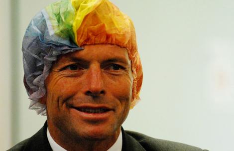 Tony Abbott wears a rainbow hair net as part of an organ donation campaign.